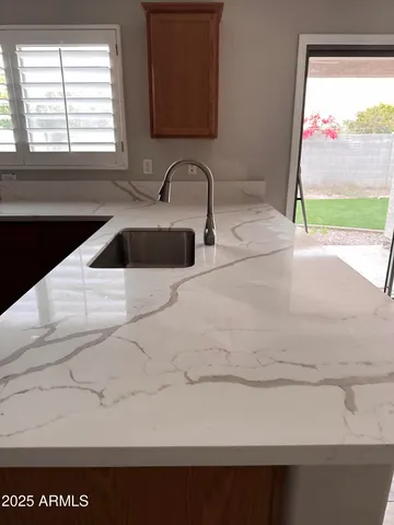 a kitchen with a sink and a large window