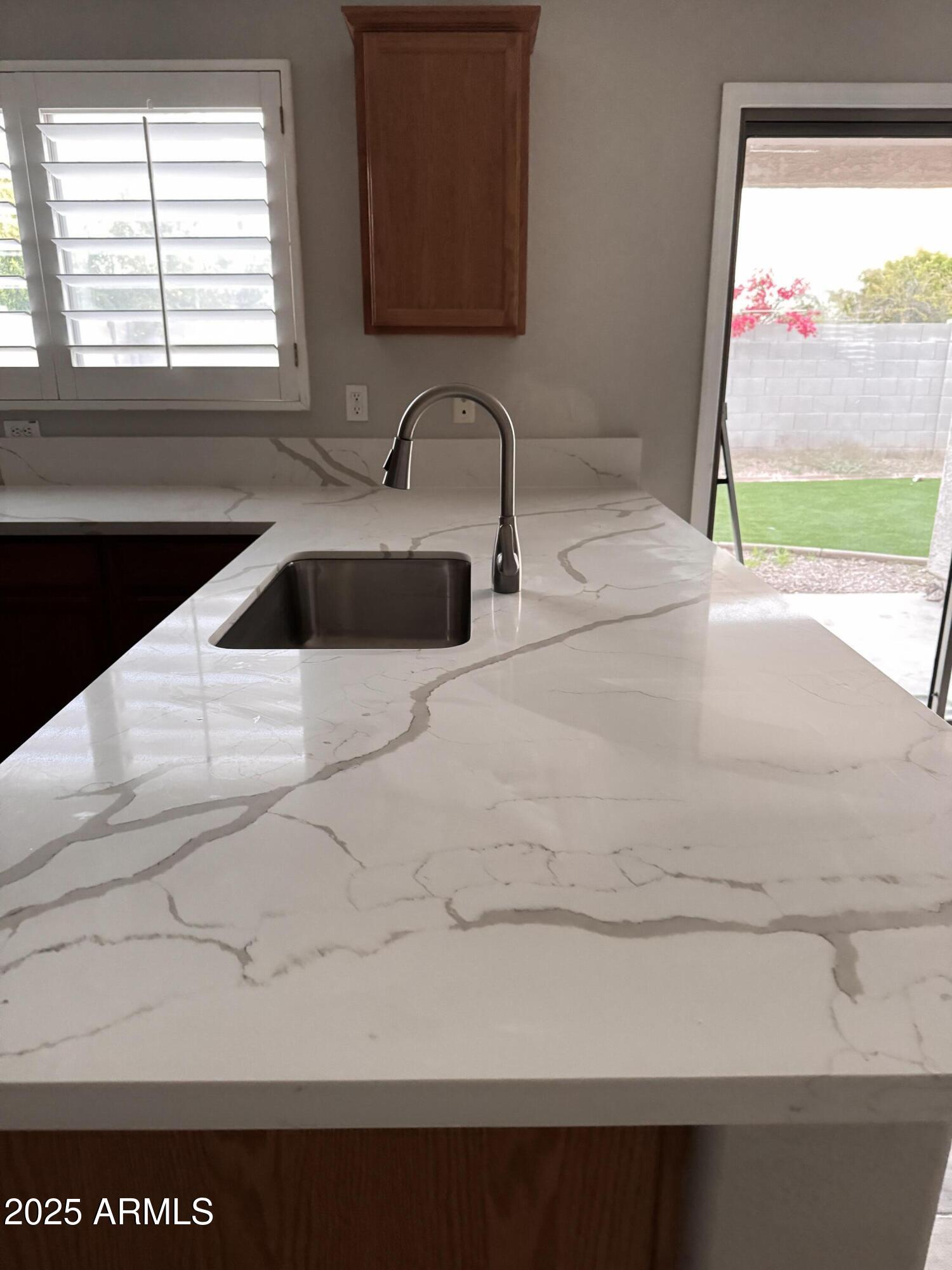 2719 South Sailors Way Gilbert, AZ 85295 - Photo 5 of 14 a kitchen with a sink and a large window