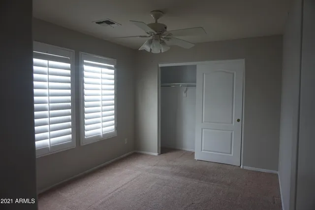 a view of a livingroom with a ceiling fan and window