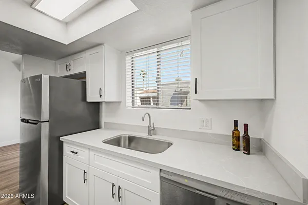 a kitchen with a refrigerator a sink and dishwasher