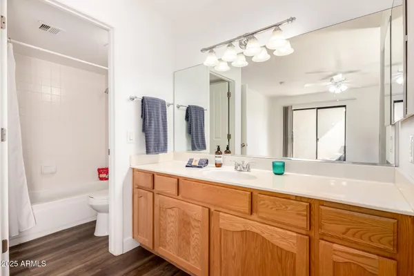 a view of a room with wooden floor and bathroom