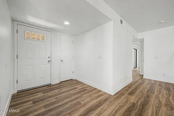 a view of a room with wooden floor and white doors