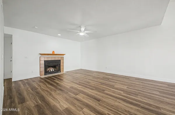 a view of empty room with fireplace and fan