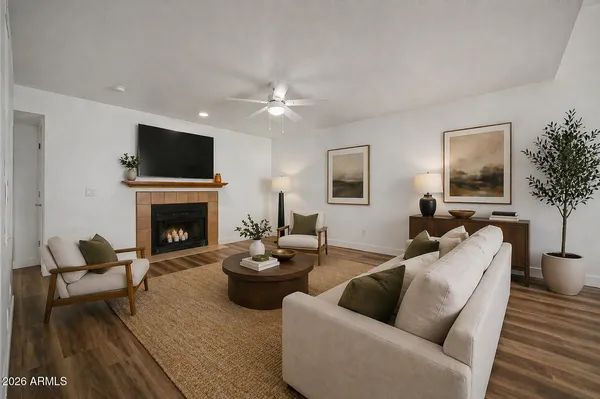 a living room with furniture a flat screen tv and a fireplace