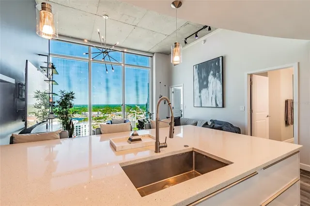 a kitchen with a sink and a large window