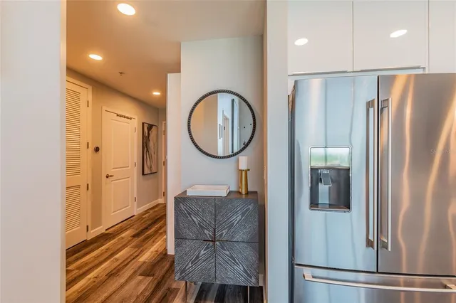 a view of a refrigerator in kitchen and a window