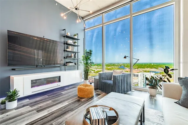 a living room with patio furniture and a floor to ceiling window
