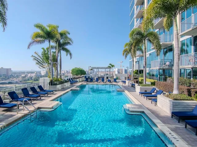 a view of swimming pool with outdoor seating and a garden
