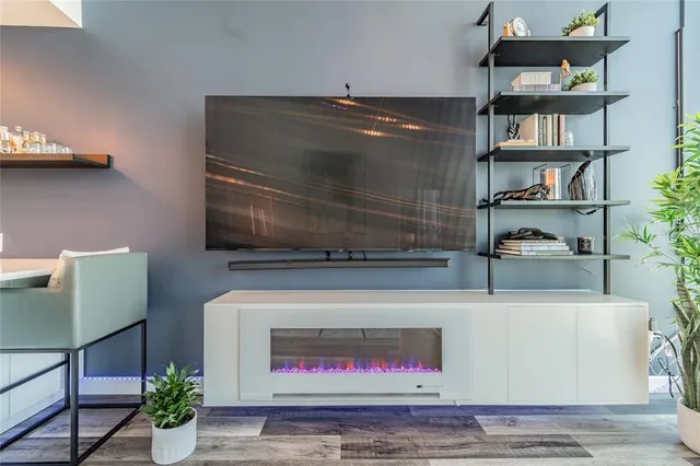 a living room with furniture and a book shelf