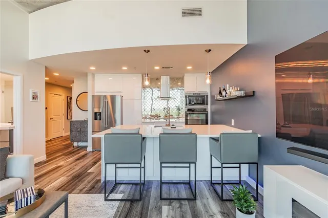 a dining room with furniture and wooden floor