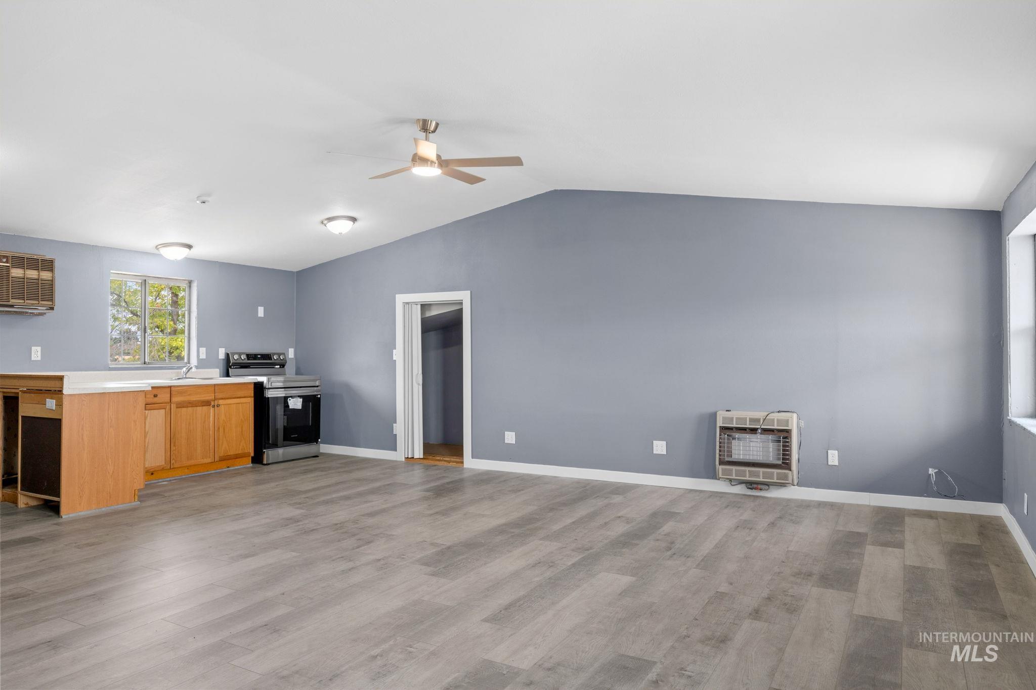 18338 Pride Lane Caldwell, ID 83607 - Photo 37 of 50 Open-concept living space with light wood-finish flooring, a vaulted ceiling, and recessed lighting