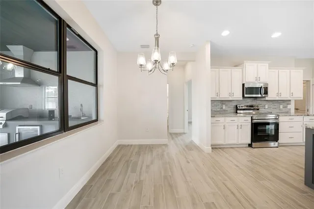 a large kitchen with granite countertop a large counter top stainless steel appliances and cabinets