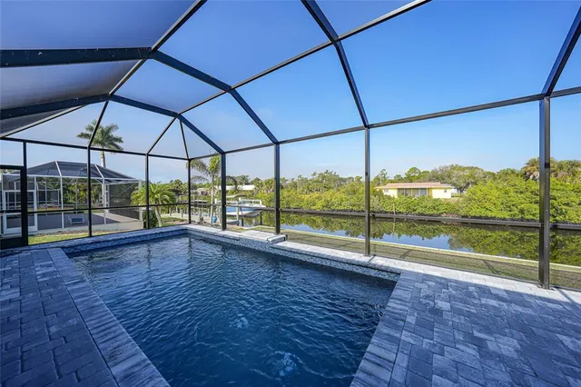 a view of a swimming pool with an outdoor seating and lake view