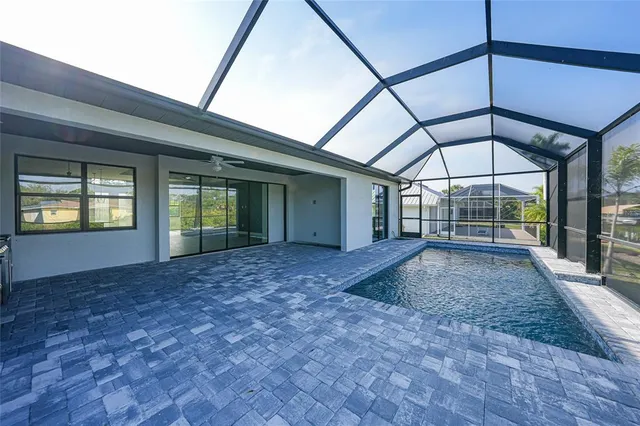 a view of a house with backyard and sitting area