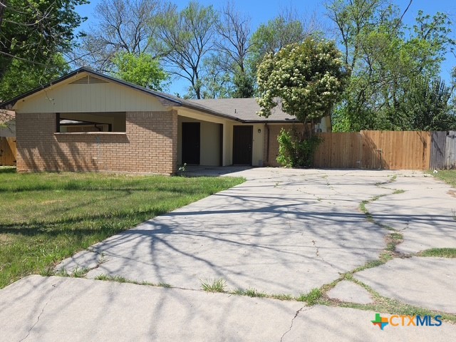 2010 South 15th Street, Unit B Temple, TX 76504 - Photo 1 of 12 a white house that has a tree in front of it