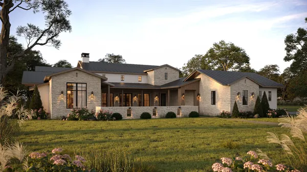a front view of a house with a garden and trees