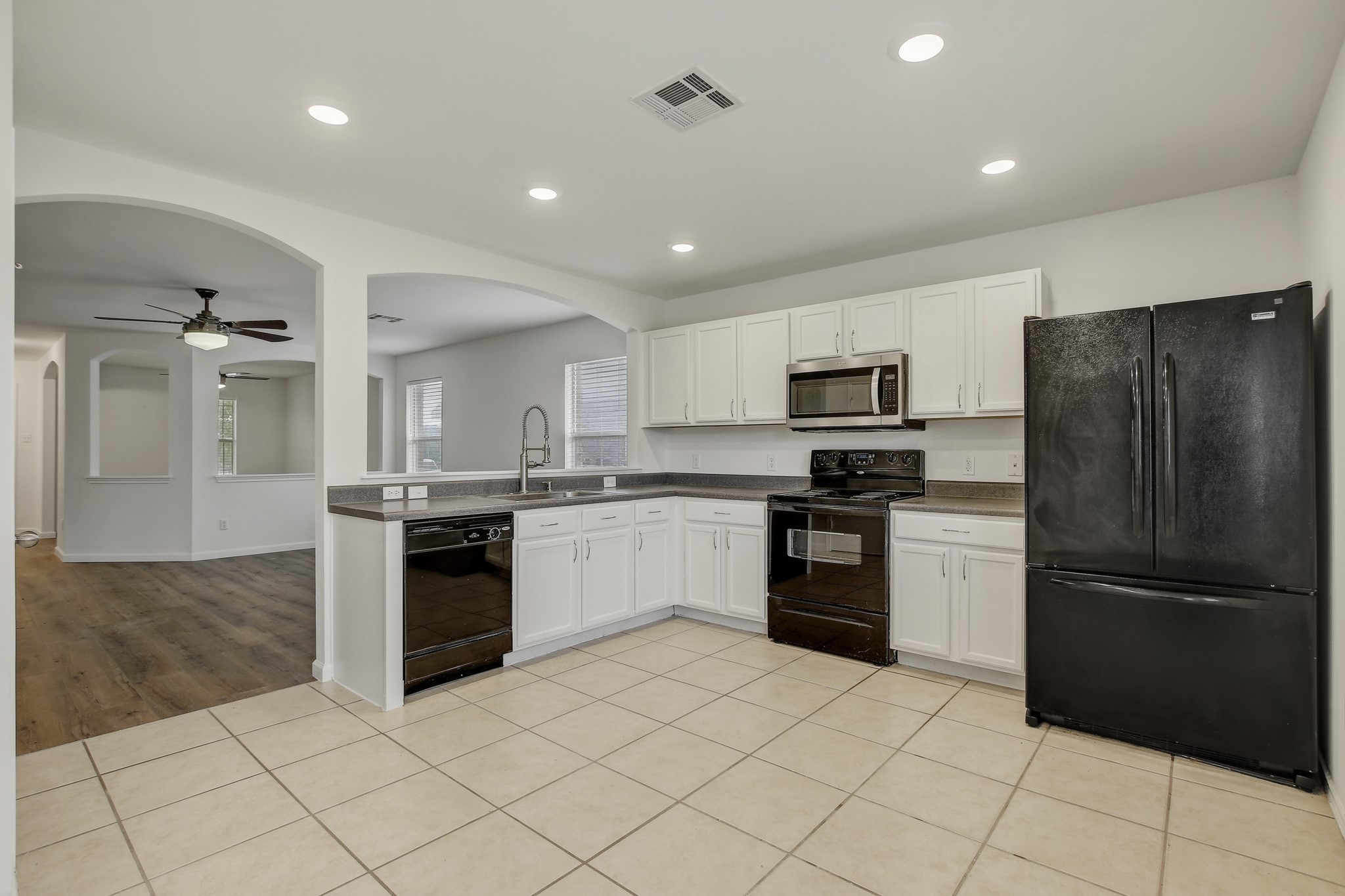 315 Northern Trail Leander, TX 78641 - Photo 12 of 30 a kitchen with granite countertop a refrigerator and a stove top oven