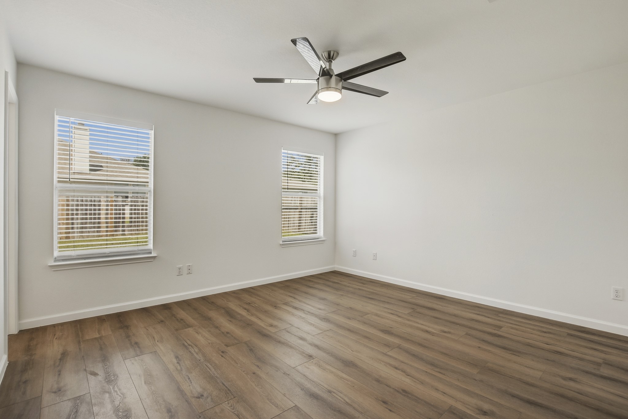 315 Northern Trail Leander, TX 78641 - Photo 17 of 30 an empty room with wooden floor fan and windows