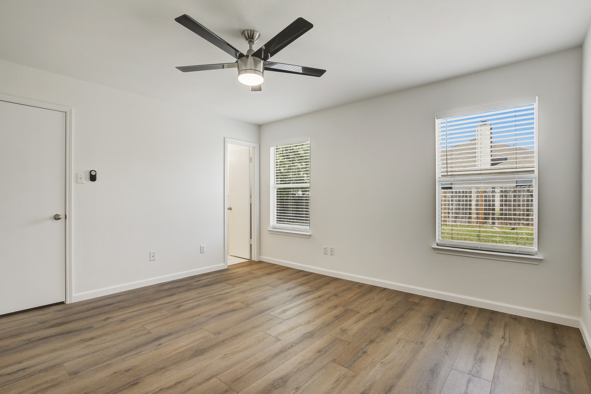 315 Northern Trail Leander, TX 78641 - Photo 18 of 30 an empty room with wooden floor and windows