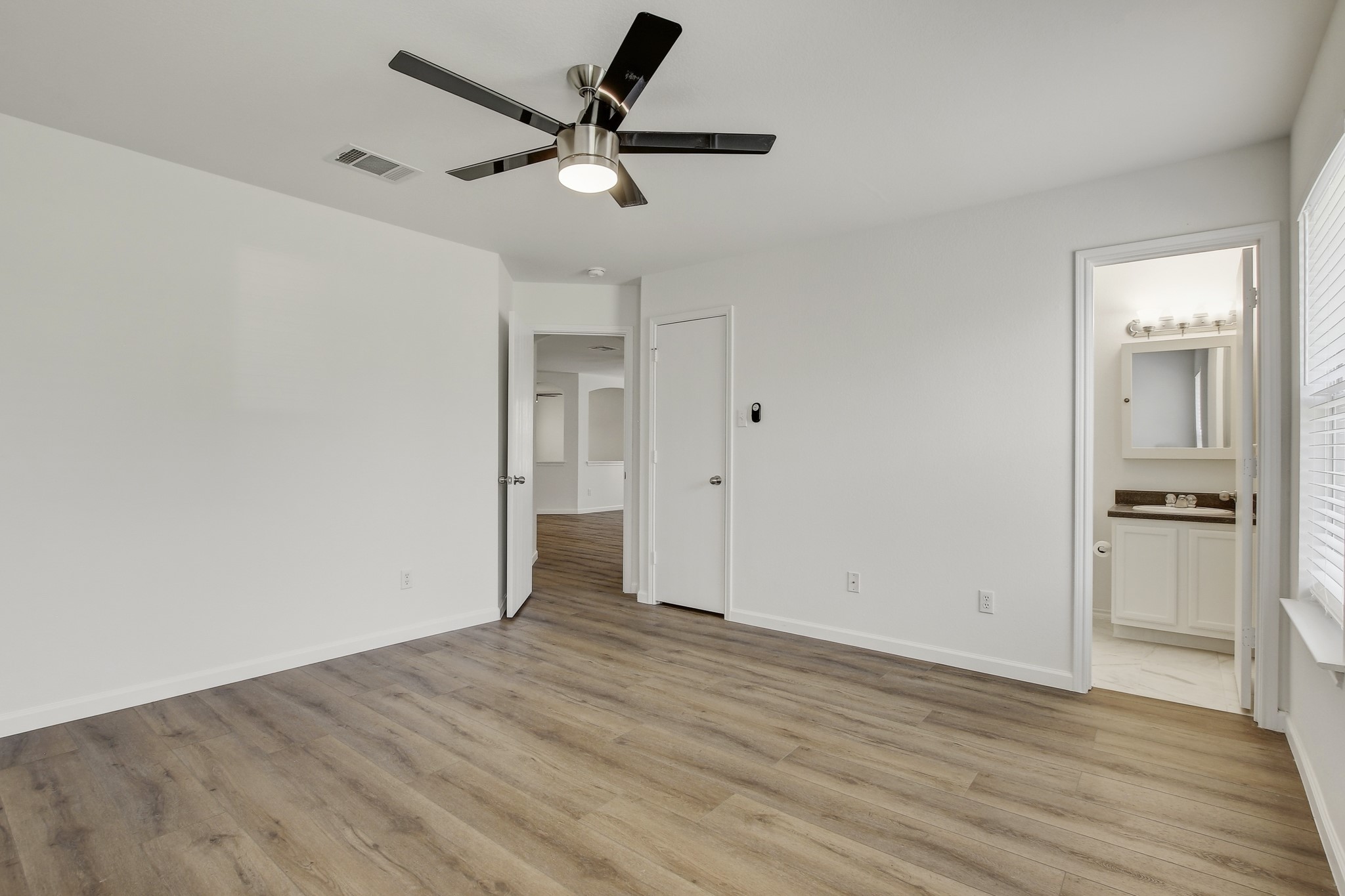 315 Northern Trail Leander, TX 78641 - Photo 19 of 30 an empty room with wooden floor and a ceiling fan