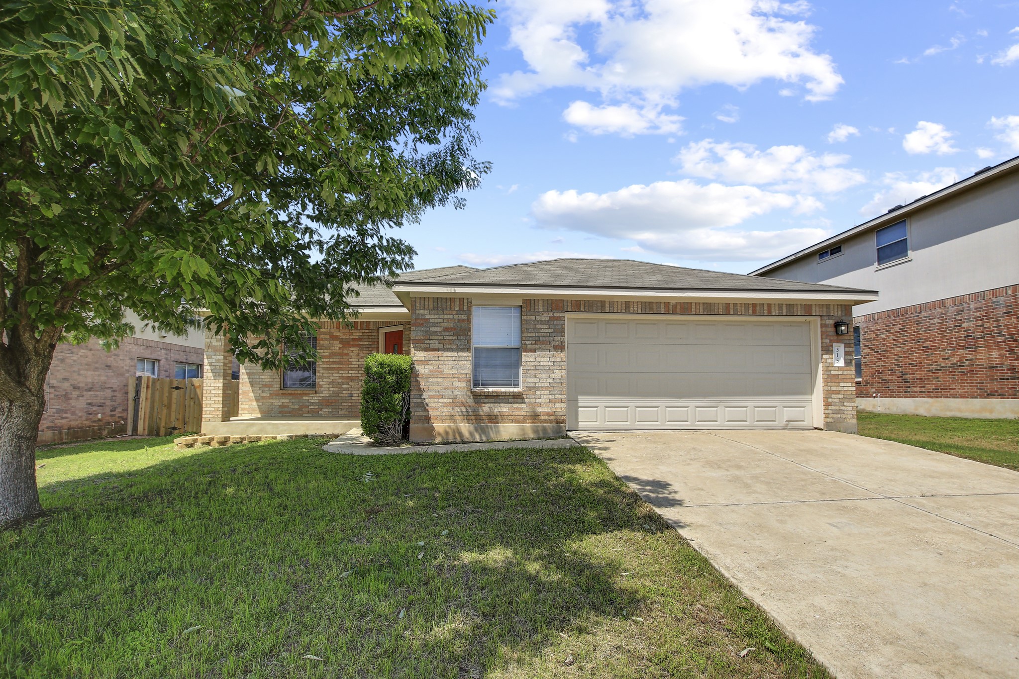 315 Northern Trail Leander, TX 78641 - Photo 2 of 30 a view of a house with a big yard and a large tree