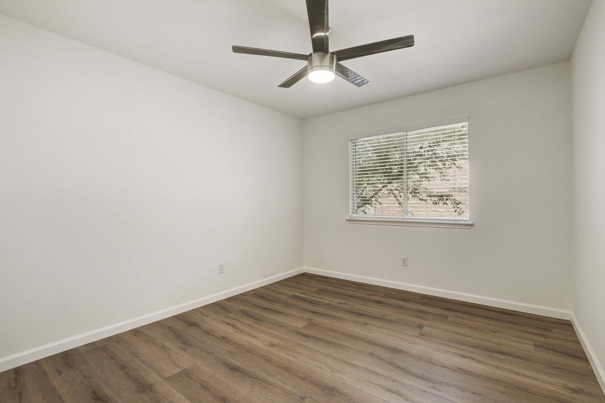 315 Northern Trail Leander, TX 78641 - Photo 25 of 30 an empty room with wooden floor and ceiling fan