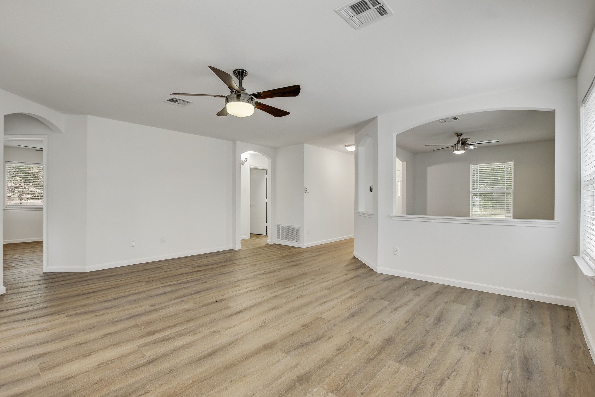 315 Northern Trail Leander, TX 78641 - Photo 5 of 30 an empty room with wooden floor and windows