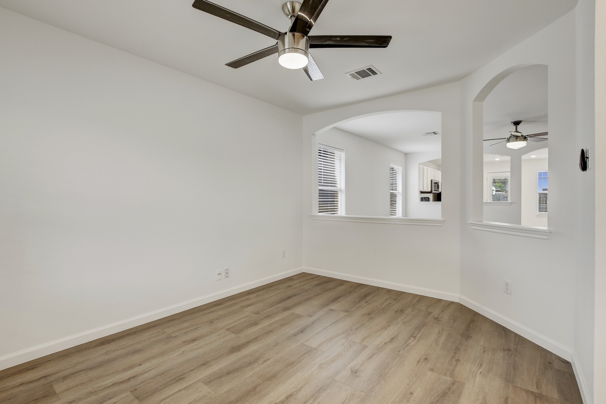 315 Northern Trail Leander, TX 78641 - Photo 10 of 30 an empty room with wooden floor and windows