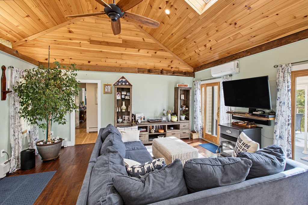 1668 Vandervort Hill Road Unadilla, NY 13849 - Photo 14 of 50 A vaulted wood ceiling and rich hardwood floors bring warmth to this comfortable living room.