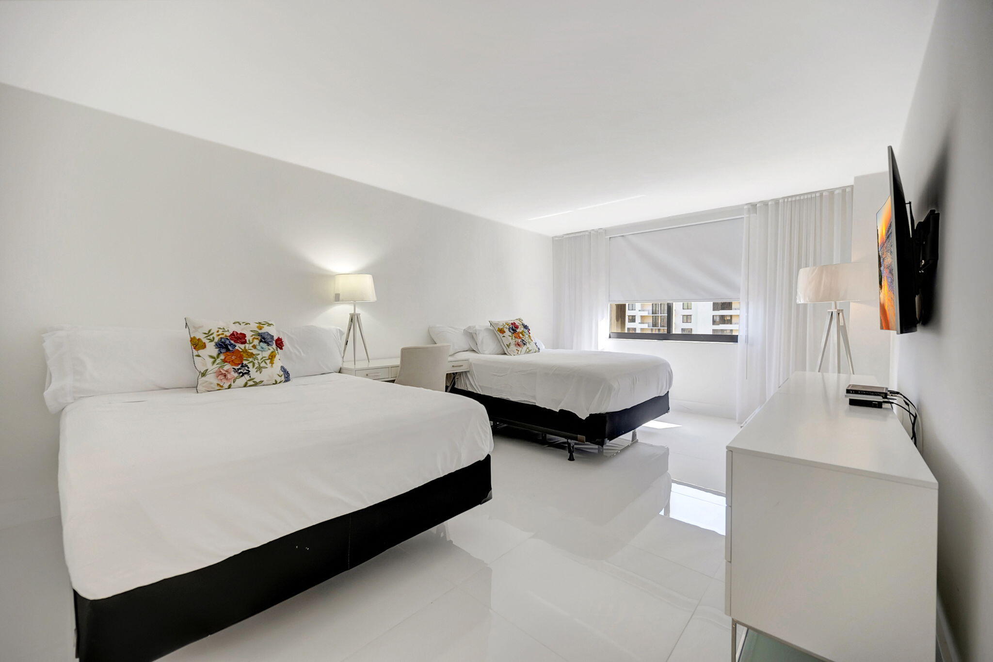 540 Brickell Key Drive, Unit 919 Miami, FL 33131 - Photo 13 of 42 a bedroom with a bed and a flat screen tv