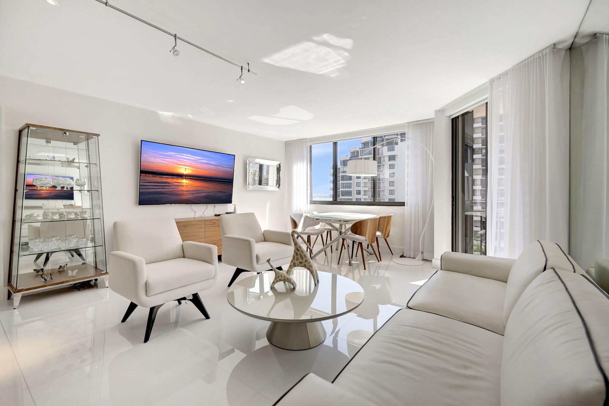 540 Brickell Key Drive, Unit 919 Miami, FL 33131 - Photo 5 of 42 a living room with furniture a flat screen tv and a window