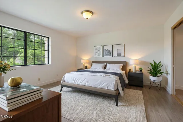 a bedroom with a bed and a window