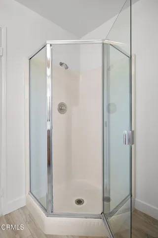 a bathroom with a glass shower door