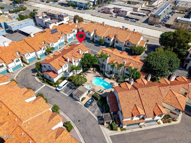 an aerial view of a house with a swimming pool