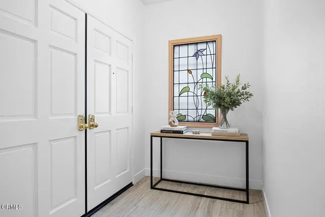 a view of an entryway with wooden floor