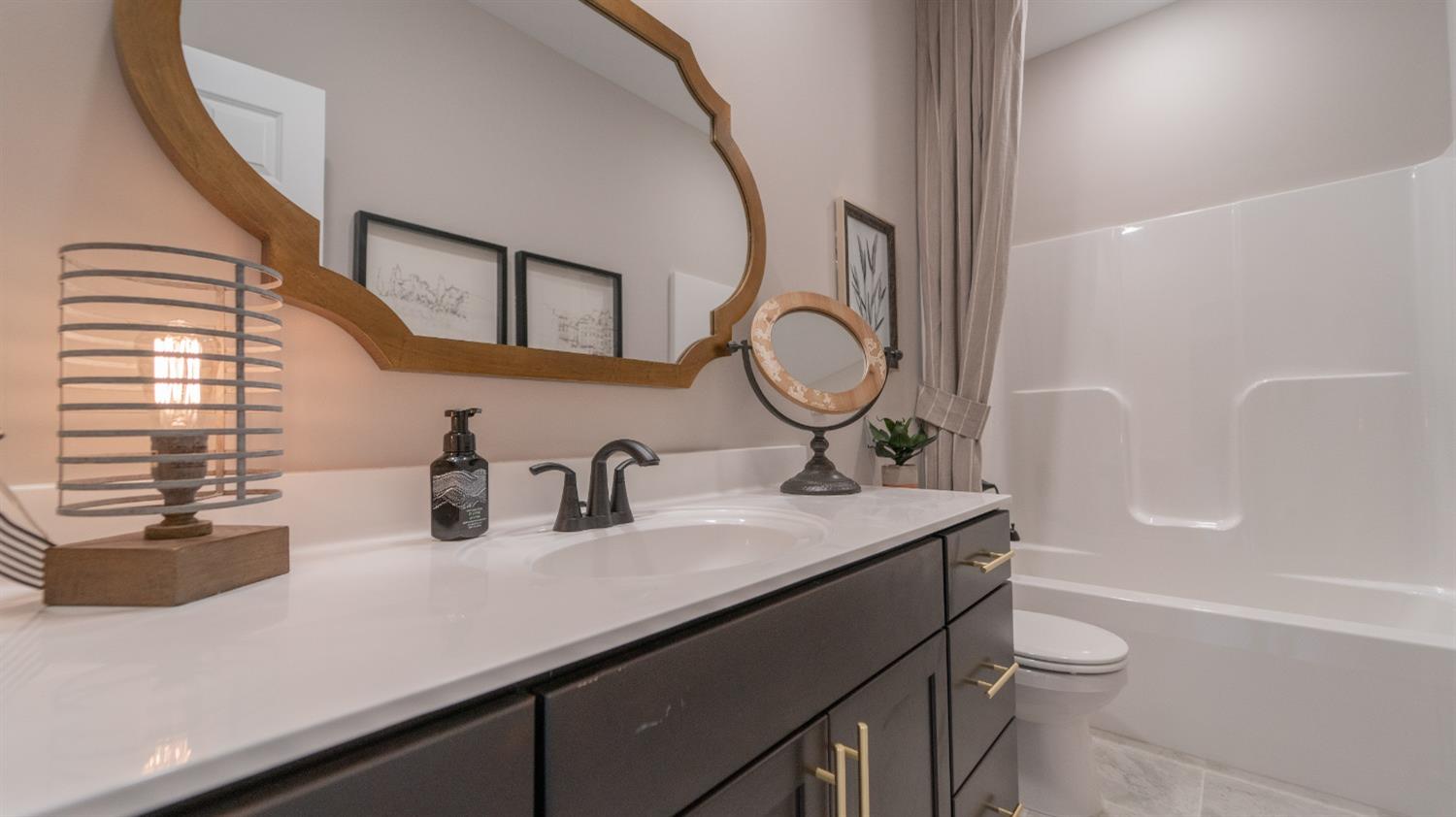 8713 Burr Rdg Circle Crown Point, IN 46307 - Photo 11 of 21 a bathroom with a granite countertop sink toilet a mirror and bathtub