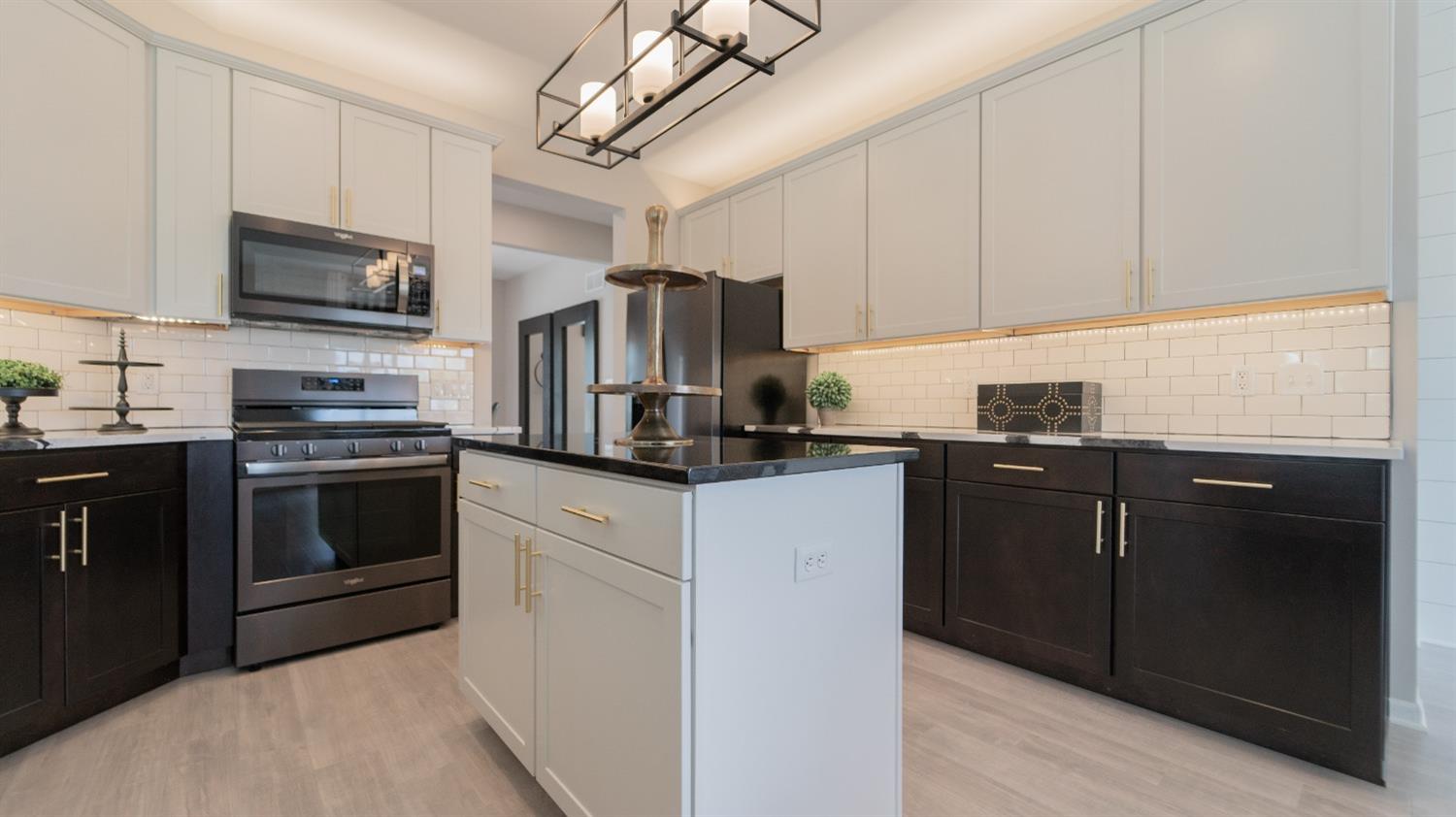 8713 Burr Rdg Circle Crown Point, IN 46307 - Photo 12 of 21 a kitchen with stainless steel appliances granite countertop a refrigerator stove a sink dishwasher and microwave oven