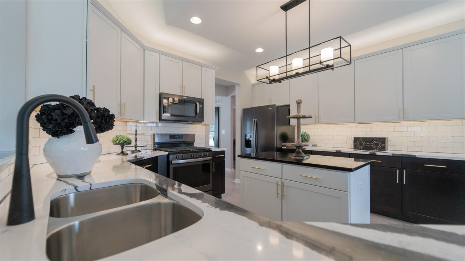 8713 Burr Rdg Circle Crown Point, IN 46307 - Photo 15 of 21 a kitchen with granite countertop a sink stainless steel appliances and white cabinets
