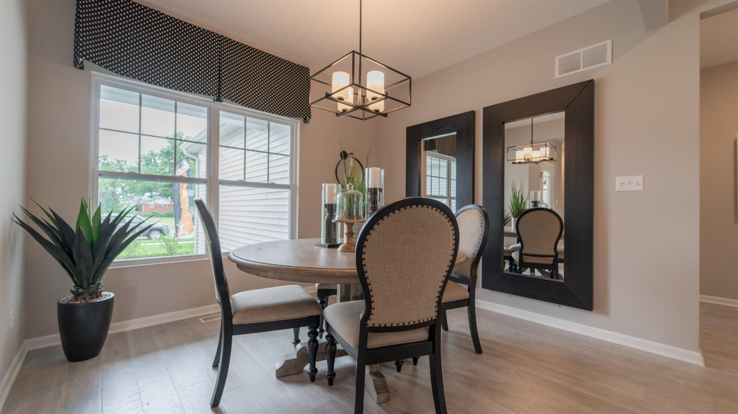 8713 Burr Rdg Circle Crown Point, IN 46307 - Photo 5 of 21 a dining room with furniture potted plants and wooden floor