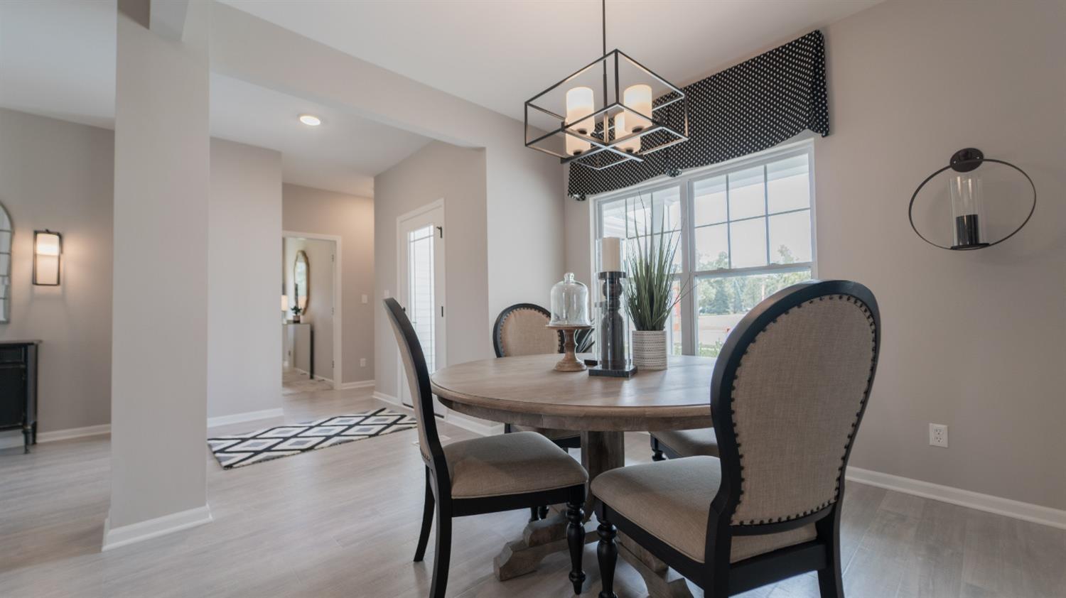 8713 Burr Rdg Circle Crown Point, IN 46307 - Photo 6 of 21 a view of a dining room with furniture and chandelier