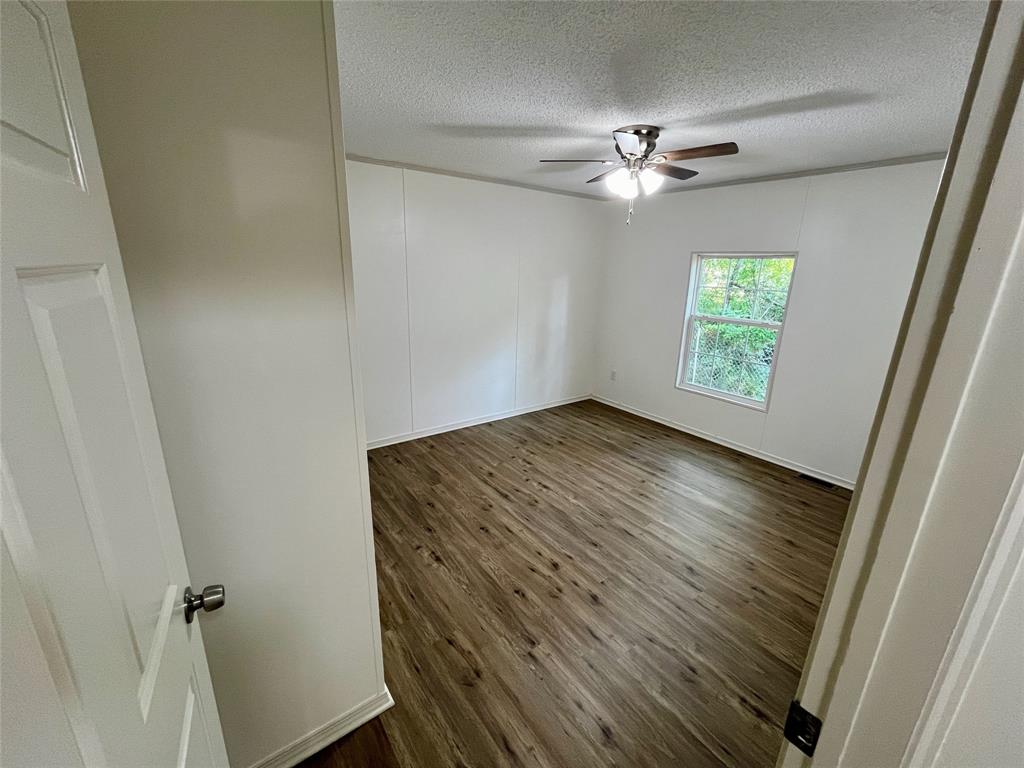 6913 Rice Road Shreveport, LA 71129 - Photo 20 of 26 wooden floor in an empty room with a window