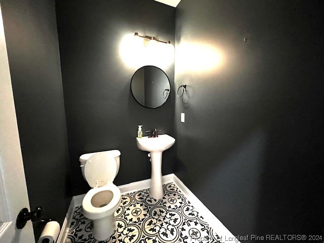 4437 Dudley Road Fayetteville, NC 28312 - Photo 17 of 41 a bathroom with a toilet sink and mirror
