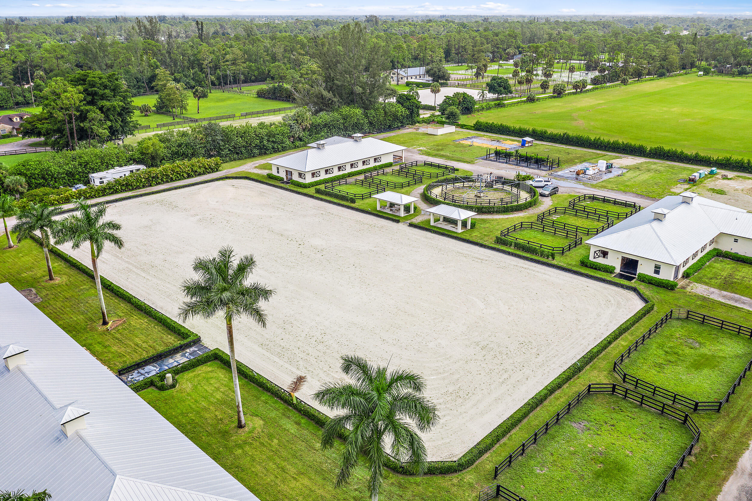 1150 F Road Loxahatchee Groves, FL 33470 - Photo 1 of 33 an aerial view of a house with a garden and lake view