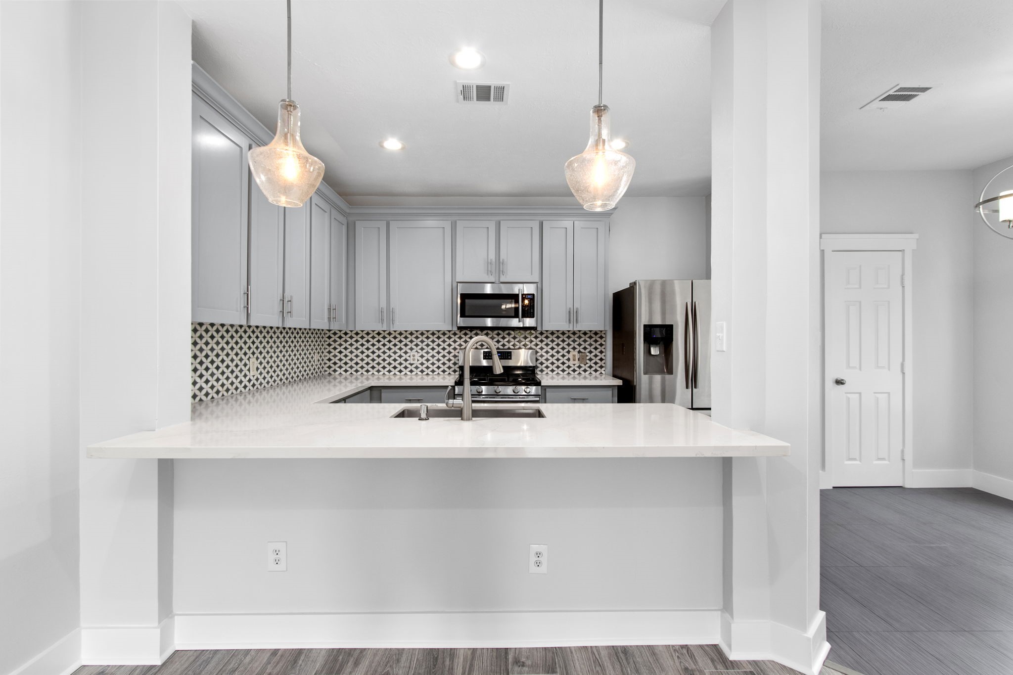 1213 Nagle Street Houston, TX 77003 - Photo 8 of 25 a kitchen with kitchen island white cabinets and stainless steel appliances