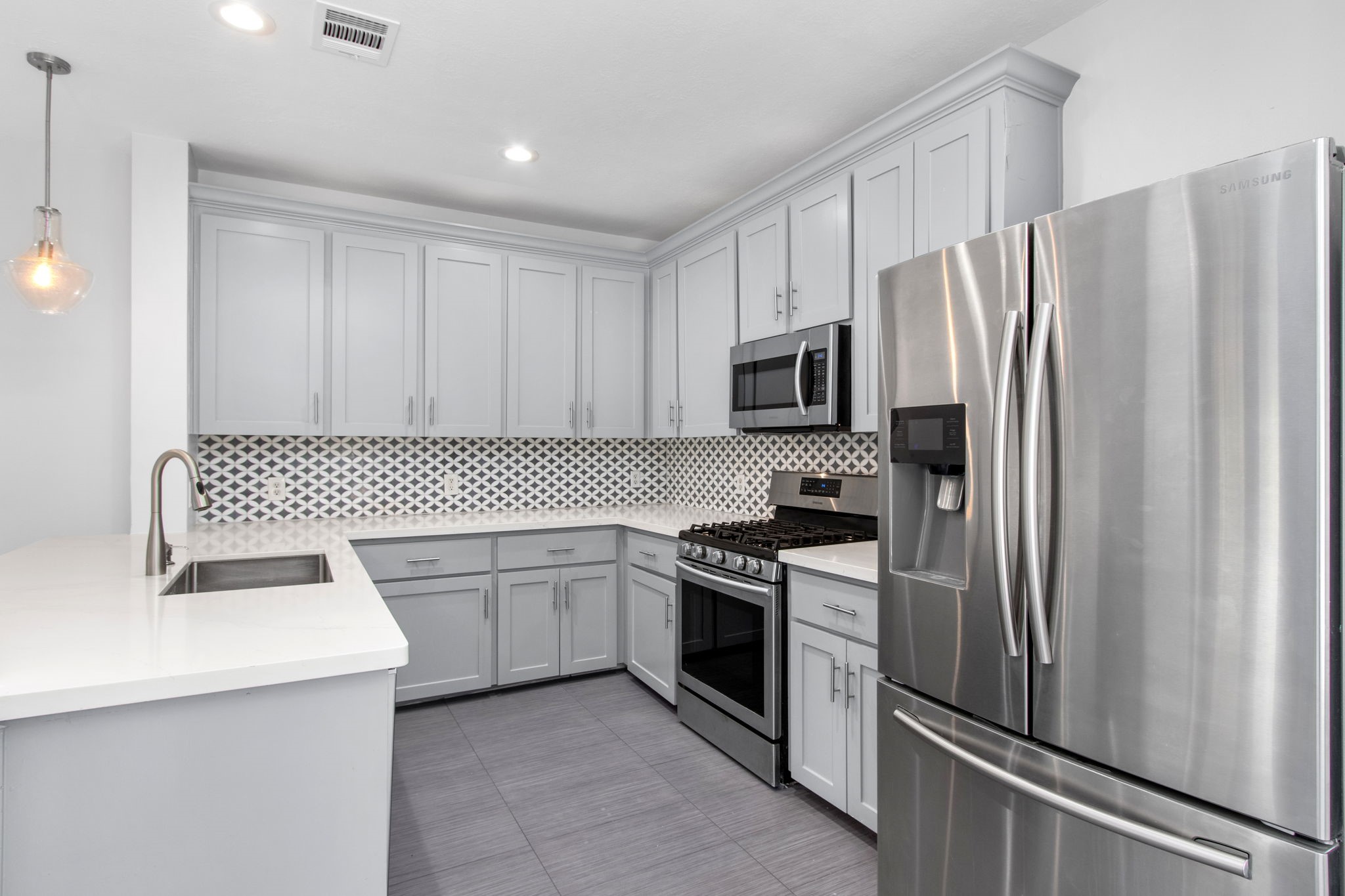 1213 Nagle Street Houston, TX 77003 - Photo 9 of 25 a kitchen with white cabinets sink and stainless steel appliances