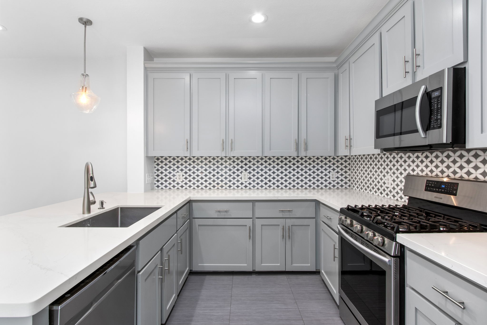 1213 Nagle Street Houston, TX 77003 - Photo 10 of 25 a kitchen with a sink stove and microwave