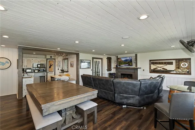 a living room with furniture a rug and kitchen view