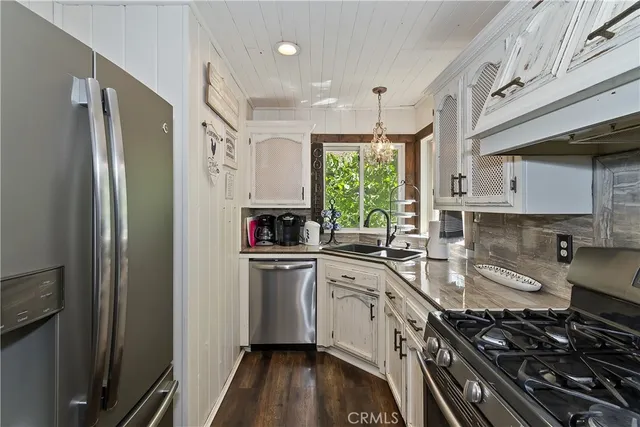 a kitchen with stainless steel appliances a sink stove and refrigerator