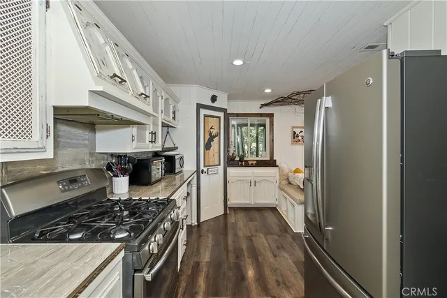 a kitchen with stainless steel appliances a stove a sink and a refrigerator