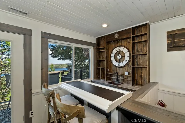 a view of a room with a table and chairs